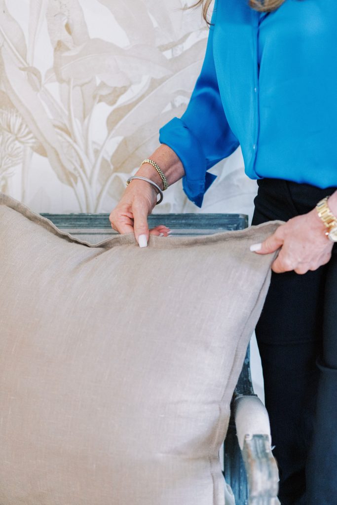 A woman moving a tan pillow